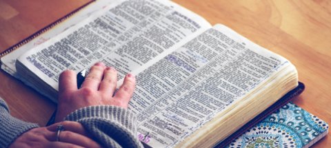 bible and ladies hand
