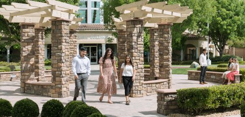Students talking and walking on campus at WCBC